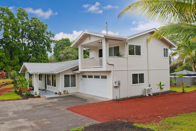 view of front of property with a garage, a balcony, and ac unit