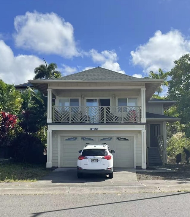 view of front facade with a balcony and a garage