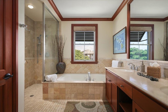 bathroom with vanity, crown molding, plenty of natural light, and separate shower and tub