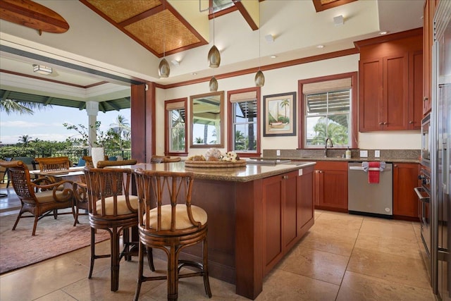 kitchen with pendant lighting, sink, dishwasher, dark stone countertops, and a center island