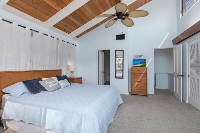 bedroom featuring light carpet, visible vents, a ceiling fan, wooden ceiling, and beam ceiling