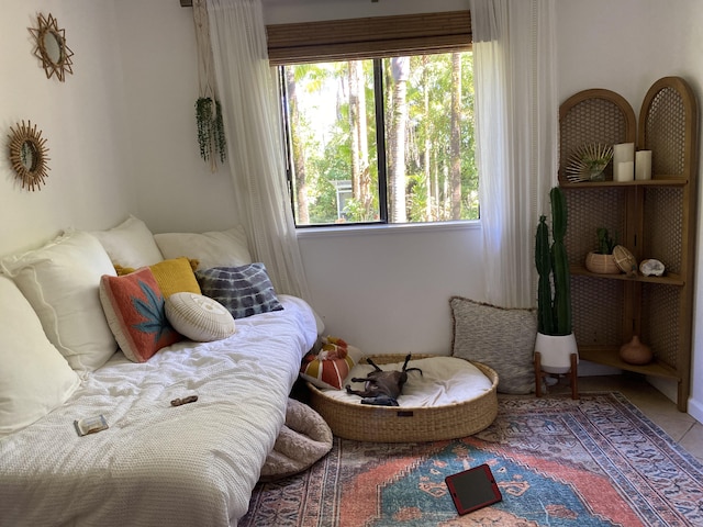 living area with plenty of natural light and tile patterned flooring