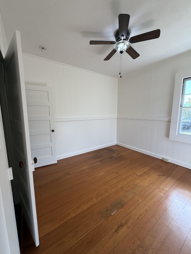 unfurnished room with ceiling fan and dark hardwood / wood-style flooring