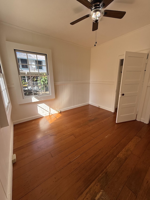 empty room featuring ceiling fan and dark hardwood / wood-style floors