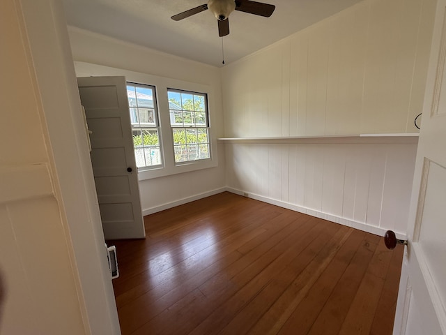 spare room with dark hardwood / wood-style floors and ceiling fan