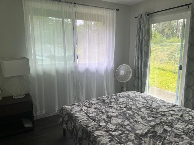 bedroom with dark hardwood / wood-style flooring