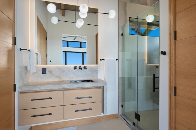 bathroom featuring vanity and a shower with shower door