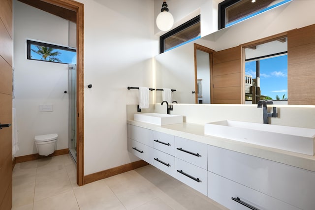 bathroom with walk in shower, tile patterned floors, vanity, and toilet