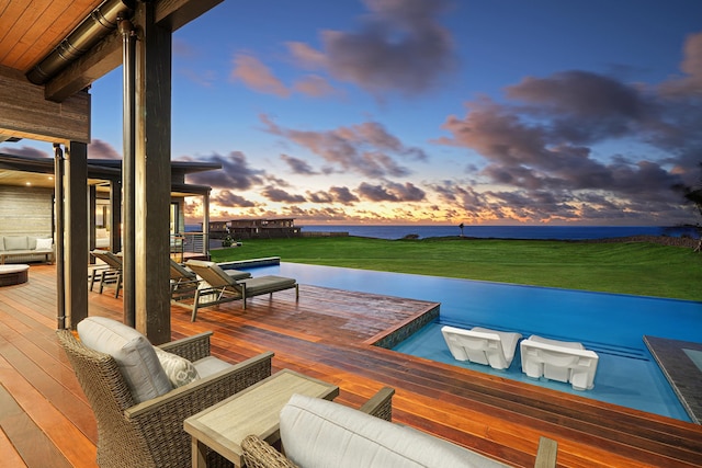 dock area with a deck with water view, an outdoor hangout area, and a lawn