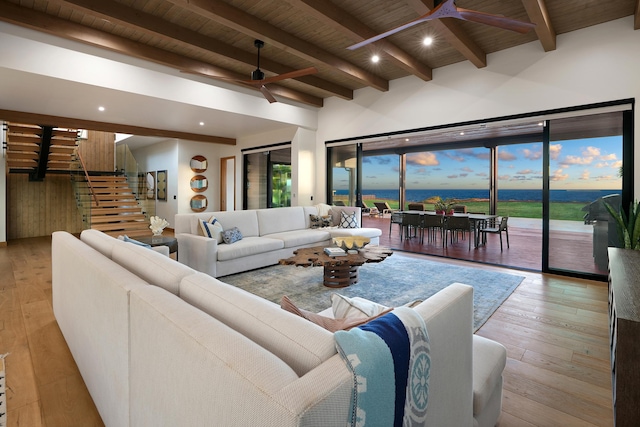 living room featuring hardwood / wood-style flooring, ceiling fan, a water view, and wood ceiling