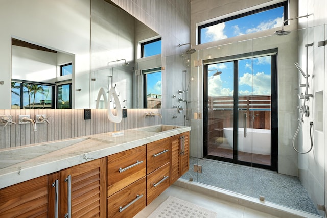 bathroom featuring tile patterned floors, vanity, and an enclosed shower