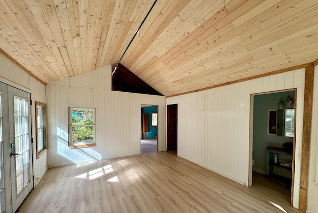 spare room with light wood-type flooring, wood ceiling, vaulted ceiling, and french doors