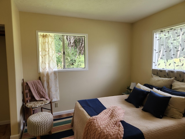 bedroom with hardwood / wood-style flooring