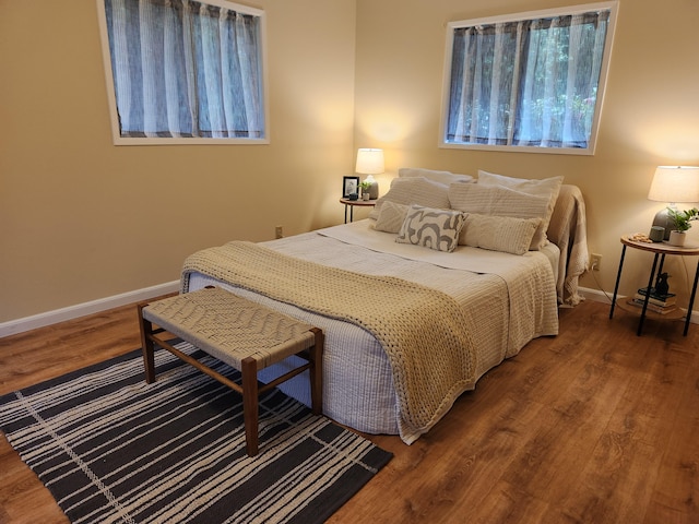 bedroom with dark wood-type flooring