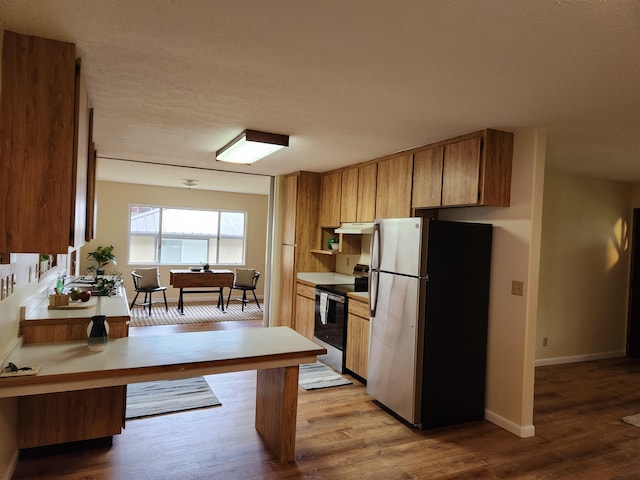 kitchen with appliances with stainless steel finishes and light wood-type flooring