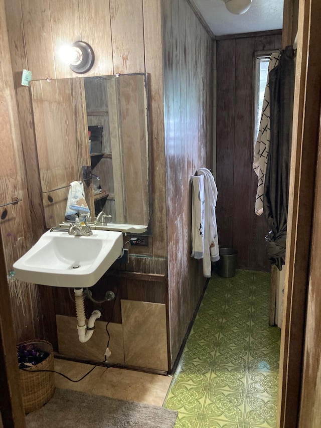 bathroom with sink and wooden walls