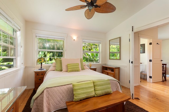 bedroom with multiple windows, vaulted ceiling, light hardwood / wood-style floors, and ceiling fan