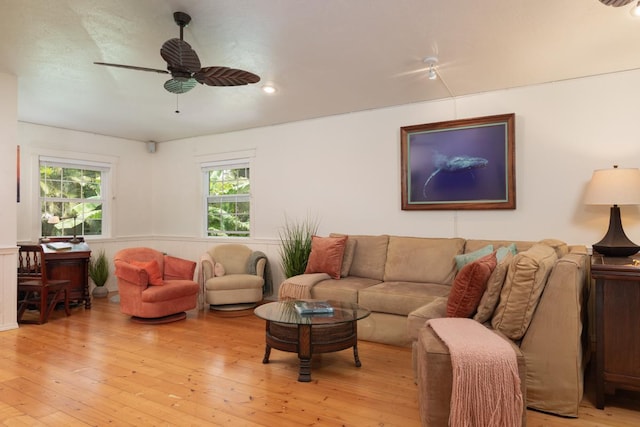 living room featuring ceiling fan and light hardwood / wood-style floors