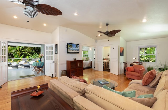 living room with lofted ceiling, light hardwood / wood-style flooring, and ceiling fan