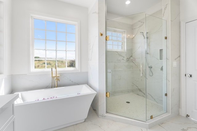 bathroom featuring a healthy amount of sunlight, shower with separate bathtub, and vanity