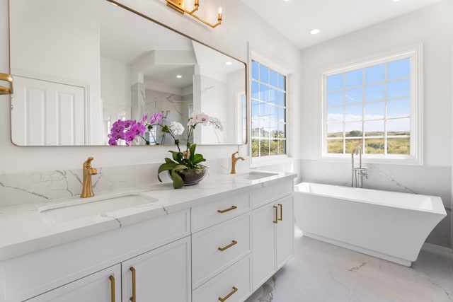 bathroom featuring vanity and a tub