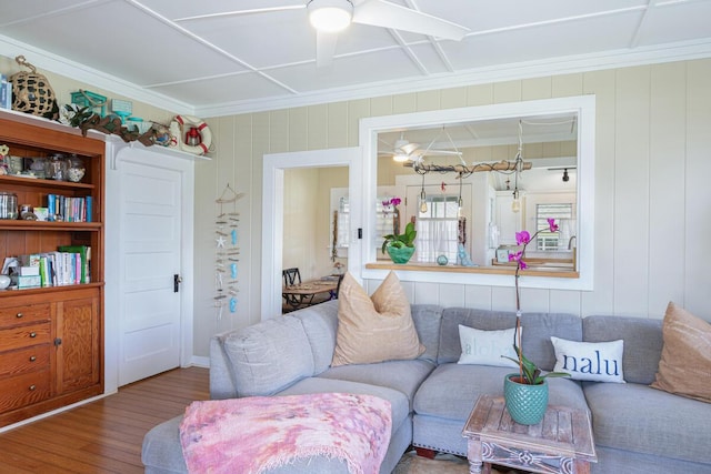 living room with hardwood / wood-style floors, crown molding, and ceiling fan