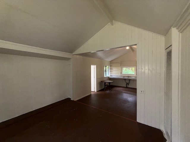 bonus room featuring lofted ceiling with beams and sink