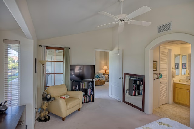 sitting room featuring high vaulted ceiling, light carpet, and ceiling fan