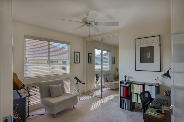 sitting room with ceiling fan, plenty of natural light, and light carpet