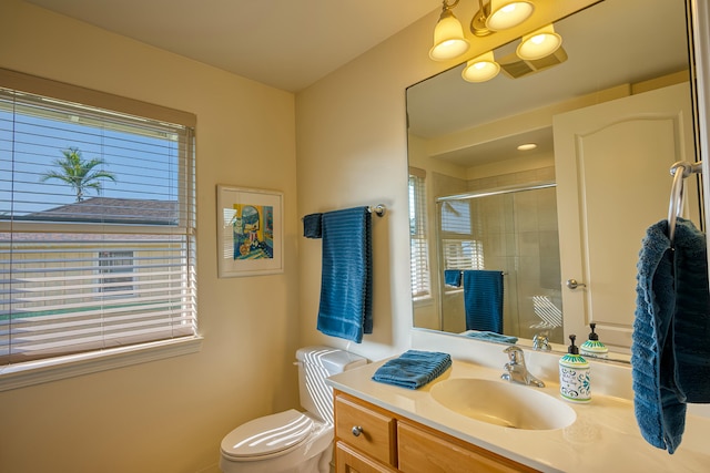 bathroom featuring walk in shower, toilet, and a wealth of natural light