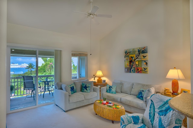 living room with ceiling fan, a water view, and high vaulted ceiling