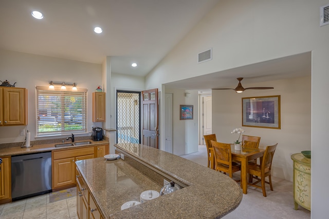 kitchen featuring light brown cabinetry, sink, light stone counters, dishwasher, and ceiling fan