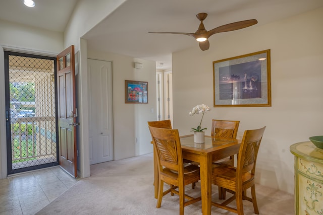 carpeted dining room featuring ceiling fan