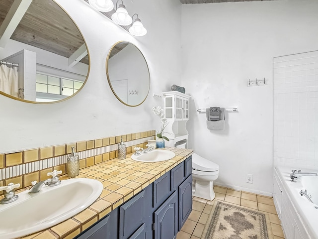 bathroom with tile patterned flooring, vanity, a bathing tub, and toilet