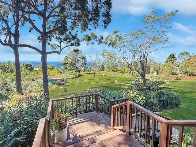 wooden terrace featuring a lawn