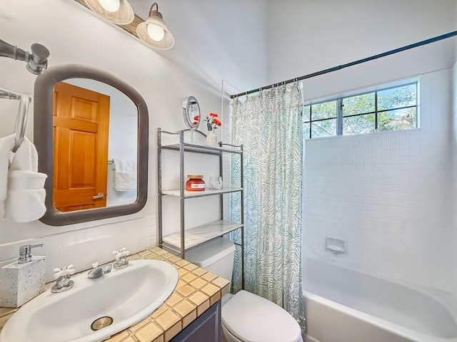 full bathroom with vanity, toilet, and shower / tub combo with curtain