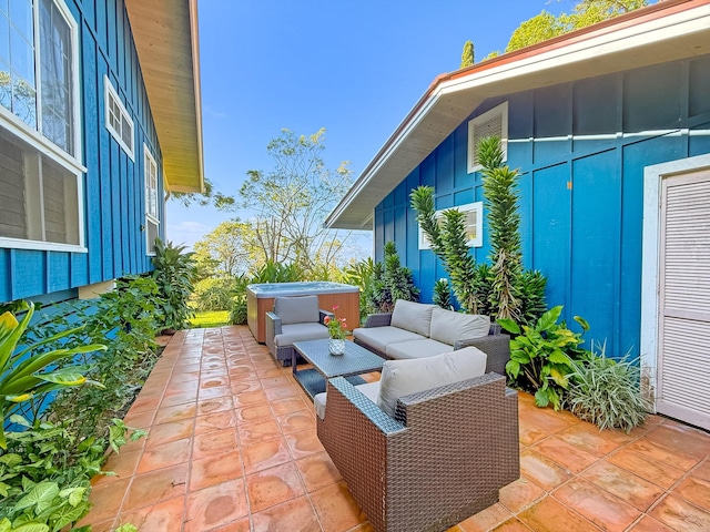 view of patio / terrace with a hot tub and an outdoor living space