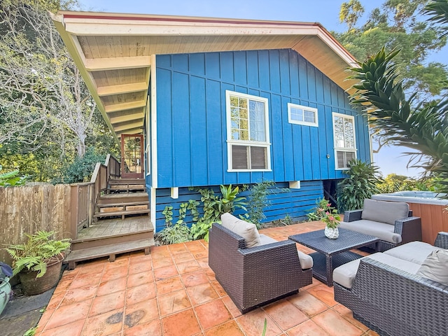 exterior space with outdoor lounge area and a hot tub