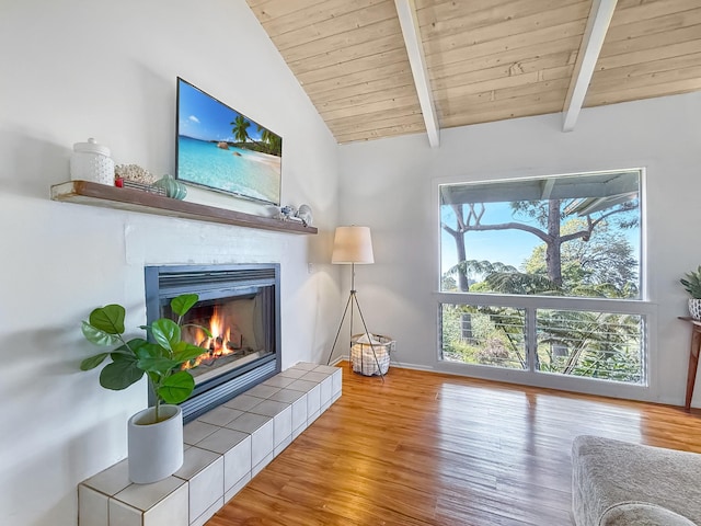 unfurnished living room with wood ceiling, a fireplace, lofted ceiling with beams, and light wood-type flooring