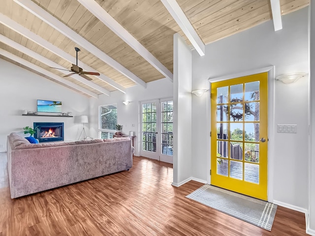 living room with hardwood / wood-style flooring, vaulted ceiling with beams, wooden ceiling, and ceiling fan