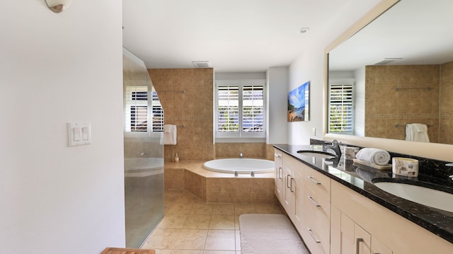 bathroom with a wealth of natural light, a sink, and a bath