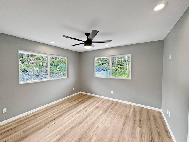 spare room featuring ceiling fan and light hardwood / wood-style floors