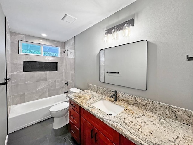 full bathroom featuring vanity, tiled shower / bath combo, and toilet