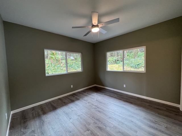 unfurnished room featuring hardwood / wood-style floors, a healthy amount of sunlight, and ceiling fan