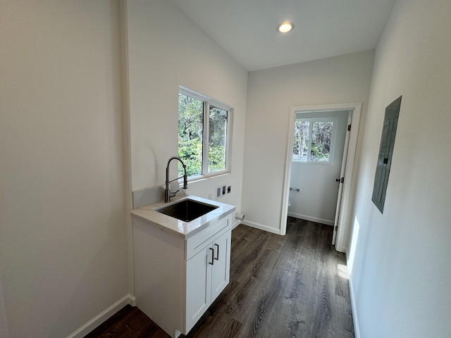 kitchen with white cabinetry, plenty of natural light, sink, and dark hardwood / wood-style flooring