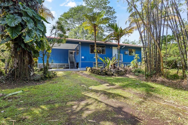 view of front facade with entry steps and a front lawn