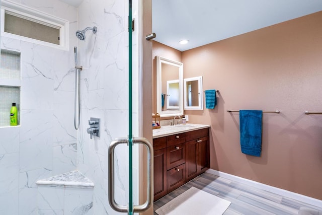 bathroom featuring tiled shower and vanity