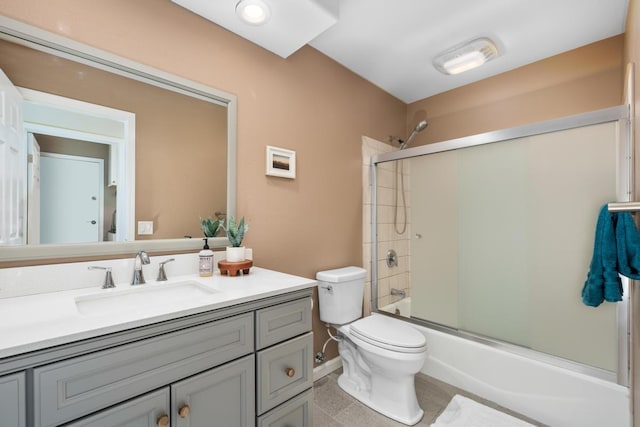 full bathroom featuring enclosed tub / shower combo, vanity, and toilet