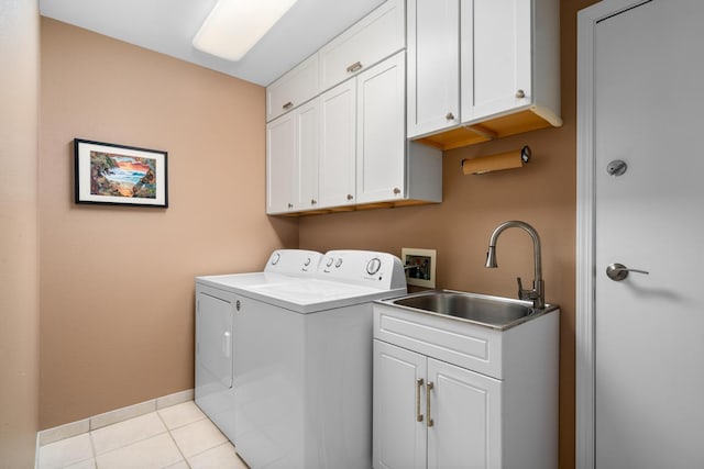 washroom with cabinets, sink, washer and dryer, and light tile patterned floors