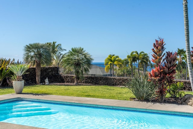 view of pool with a yard